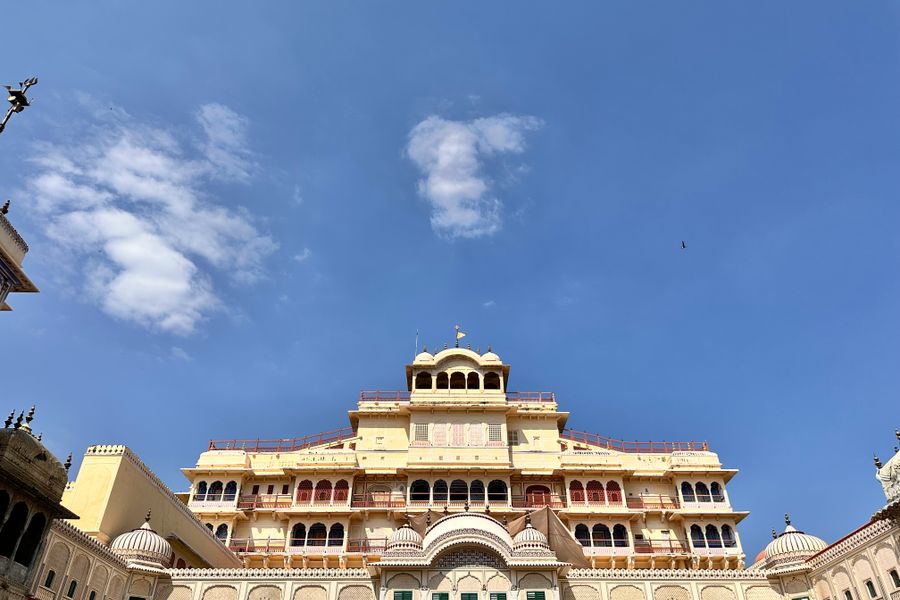 A stunning view of the City Palace in Jaipur, Rajasthan, India, with a clear blue sky backdrop.