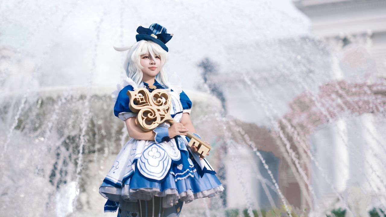 a person in detailed cosplay attire stands confidently by a fountain o