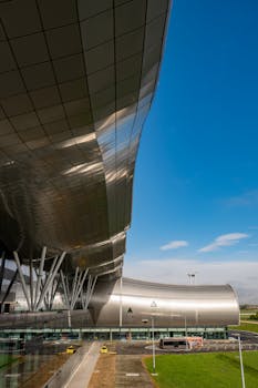 Sleek modern architectural design at Zagreb airport under a clear blue sky.