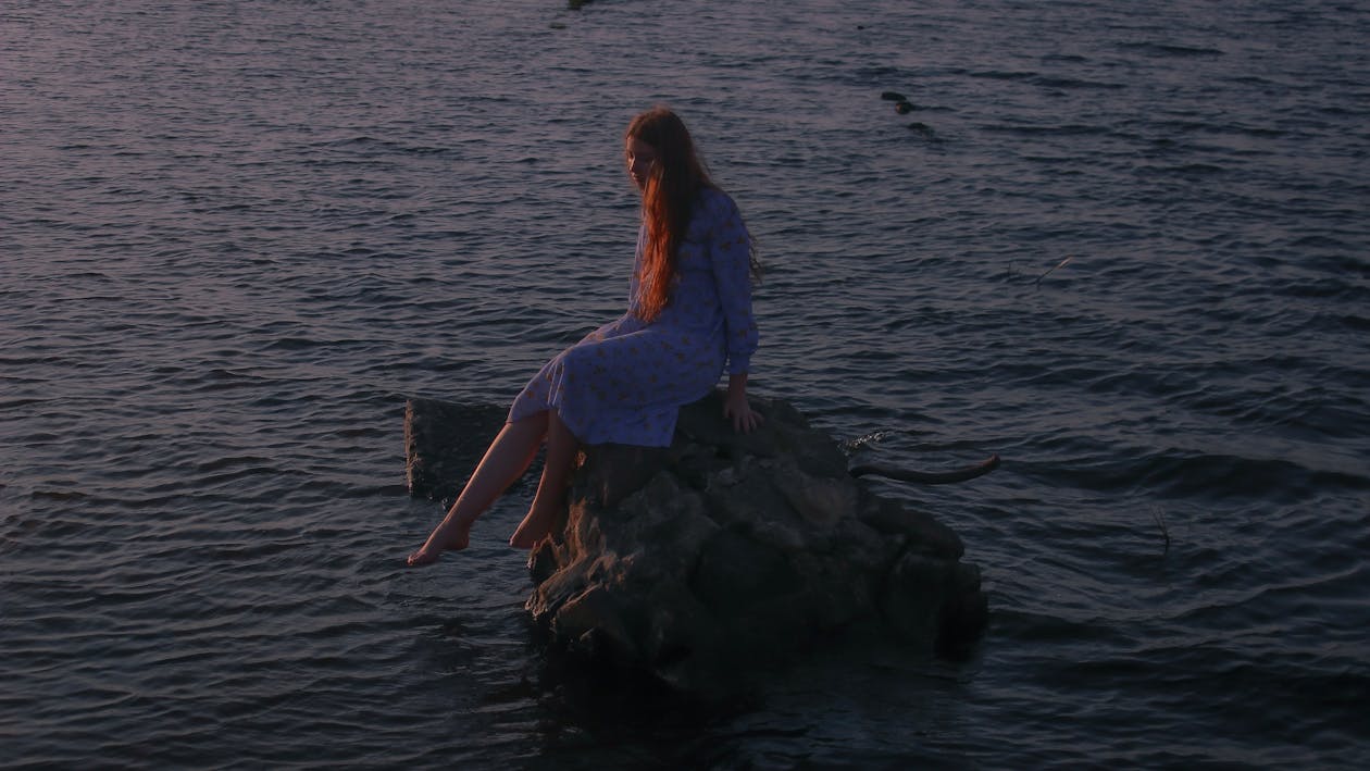 Woman Sitting on Rock