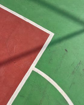 Abstract view of a green and red sports court with vibrant lines.