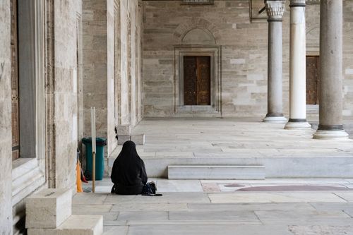 Free Lonely figure in Suleymaniye Mosque in Istanbul, highlighting architectural beauty. Stock Photo