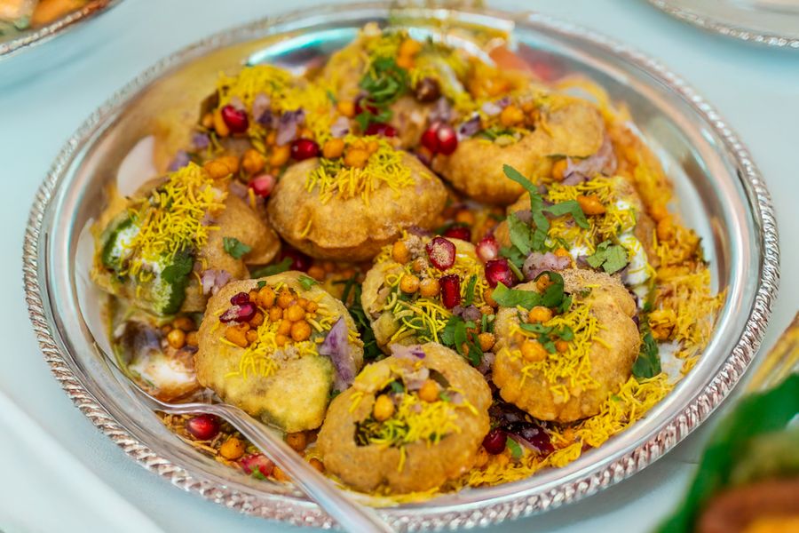 Tempting plate of crunchy Pani Puri topped with colorful garnishes.