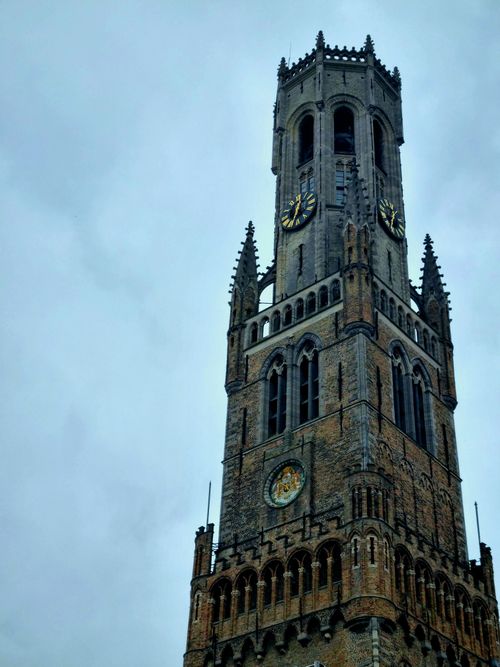 Free The iconic Belfry of Bruges stands tall against a cloudy sky, showcasing Gothic architecture. Stock Photo