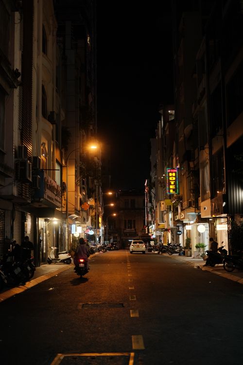 Free A serene street in Ho Chi Minh City at night, showcasing vibrant urban life. Stock Photo