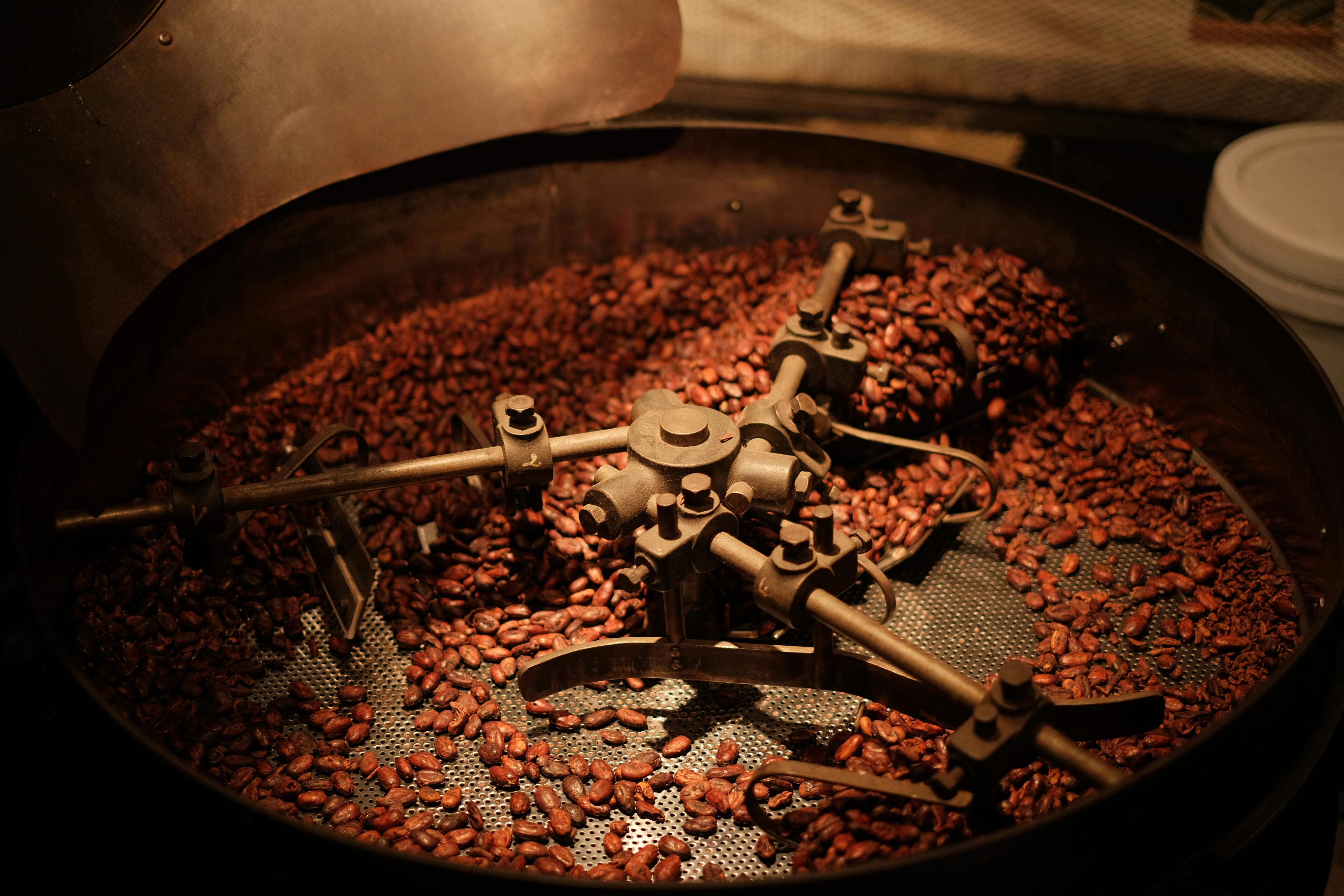 Coffee beans roasting inside a drum roaster, mid-cycle.