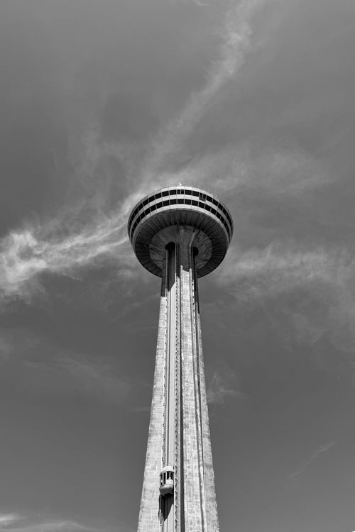 Free Monochrome view of a soaring tower under a dramatic cloudy sky. Stock Photo