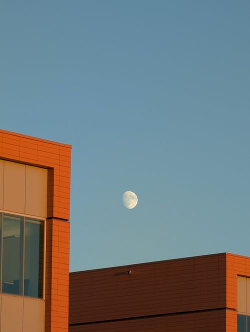 Free Contemporary architecture against a clear sky with visible moon in Sydney, Nova Scotia. Stock Photo