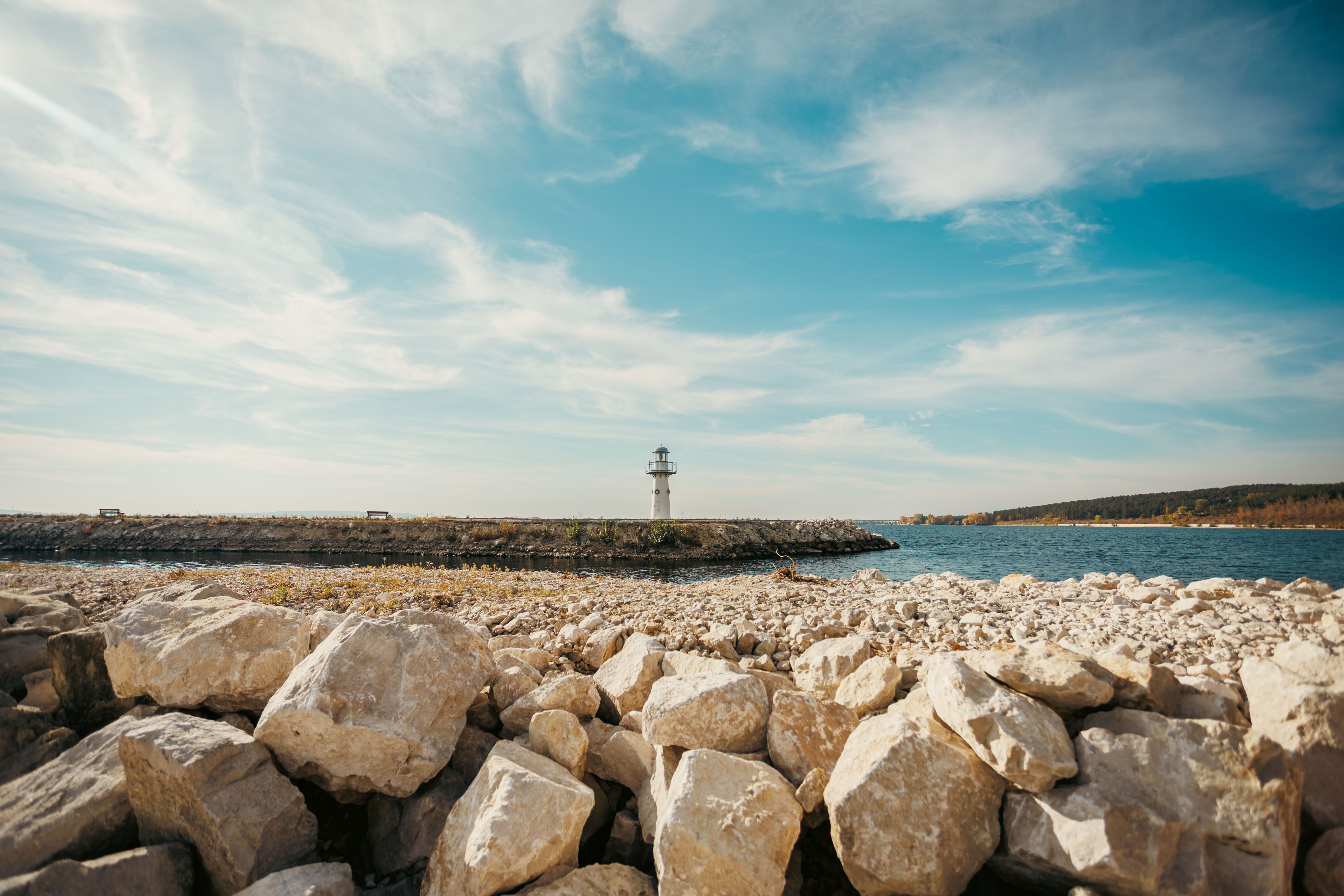 Scenic Coastal Lighthouse by Rocky Shoreline