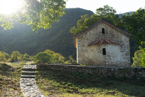 Free Stone chapel at Bachkovski Monastery, surrounded by lush greenery in Plovdiv, Bulgaria. Stock Photo
