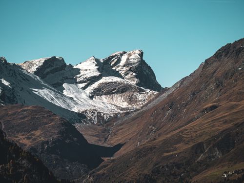 Free Breathtaking view of snow-capped mountains in Surses, Graubünden, Switzerland, showcasing winter's rustic charm. Stock Photo
