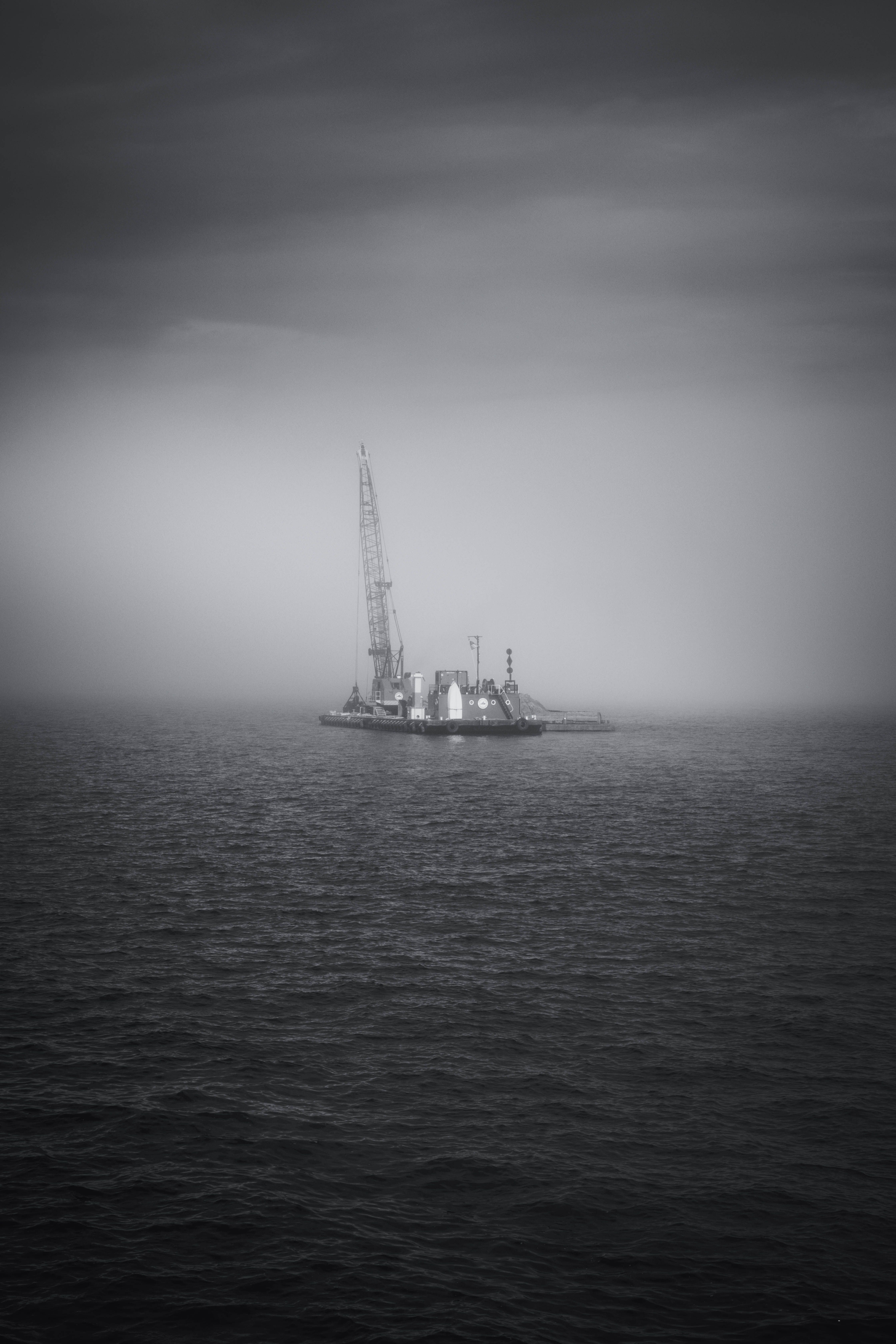 Monochrome Offshore Oil Rig in Misty Sea · Free Stock Photo