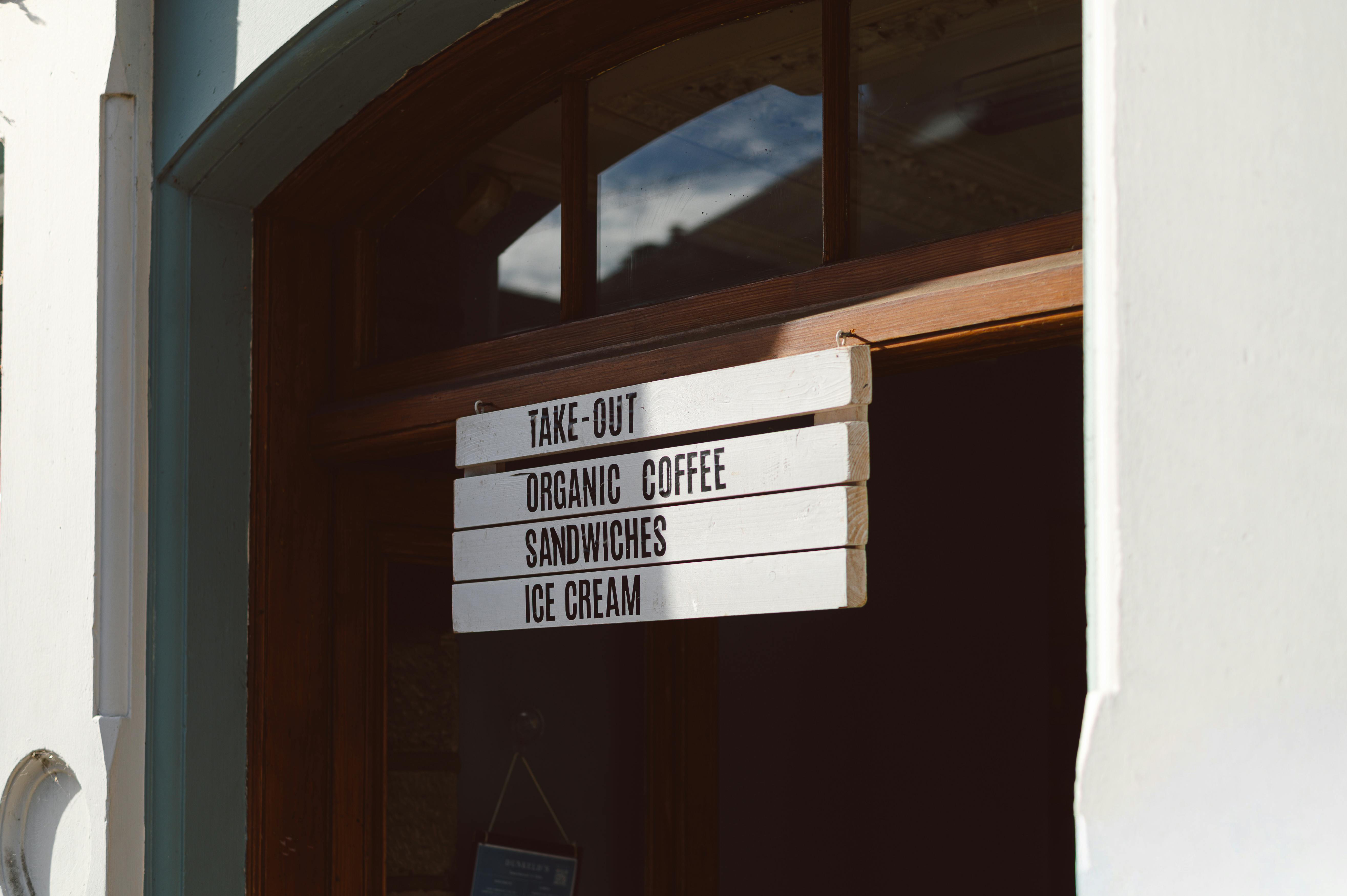 An inviting coffee shop entrance sign with menu options in Dunkeld, Scotland.
