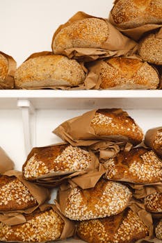 Freshly baked artisan loaves arranged on shelves at a Dunkeld bakery, showcasing traditional sourdough and seeded bread.