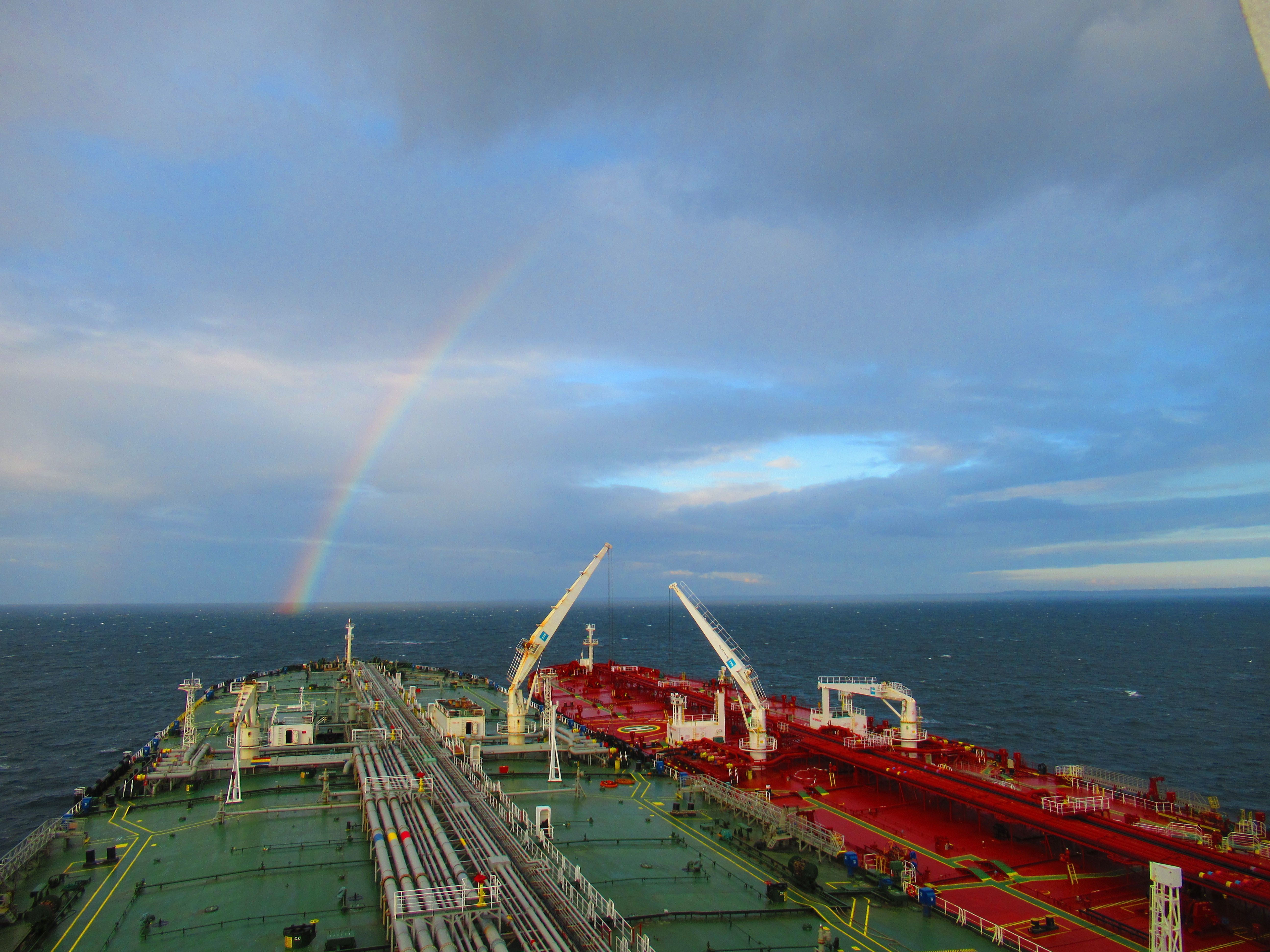 Industrial Cargo Ship with Rainbow over Ocean · Free Stock Photo