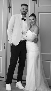 Charming black and white photo of a bride and groom in wedding attire, capturing a timeless moment.