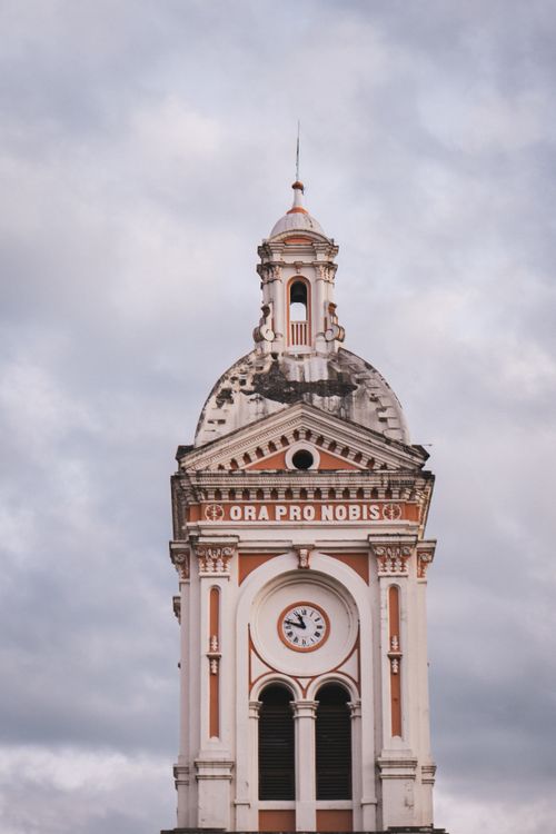Free A detailed view of a historic church tower in Ecuador, showcasing unique architectural style and design. Stock Photo