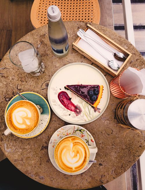 Free Top view of artisan coffee and dessert on a cafe table, capturing the charm of a Bucaramanga coffee shop. Stock Photo