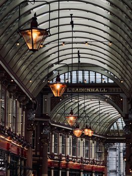 Stunning view of the historic Leadenhall Market in London with ornate architecture and warm lighting.