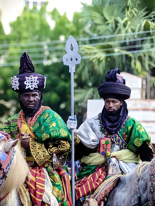 Free Two men in traditional attire on horseback during a cultural celebration. Stock Photo