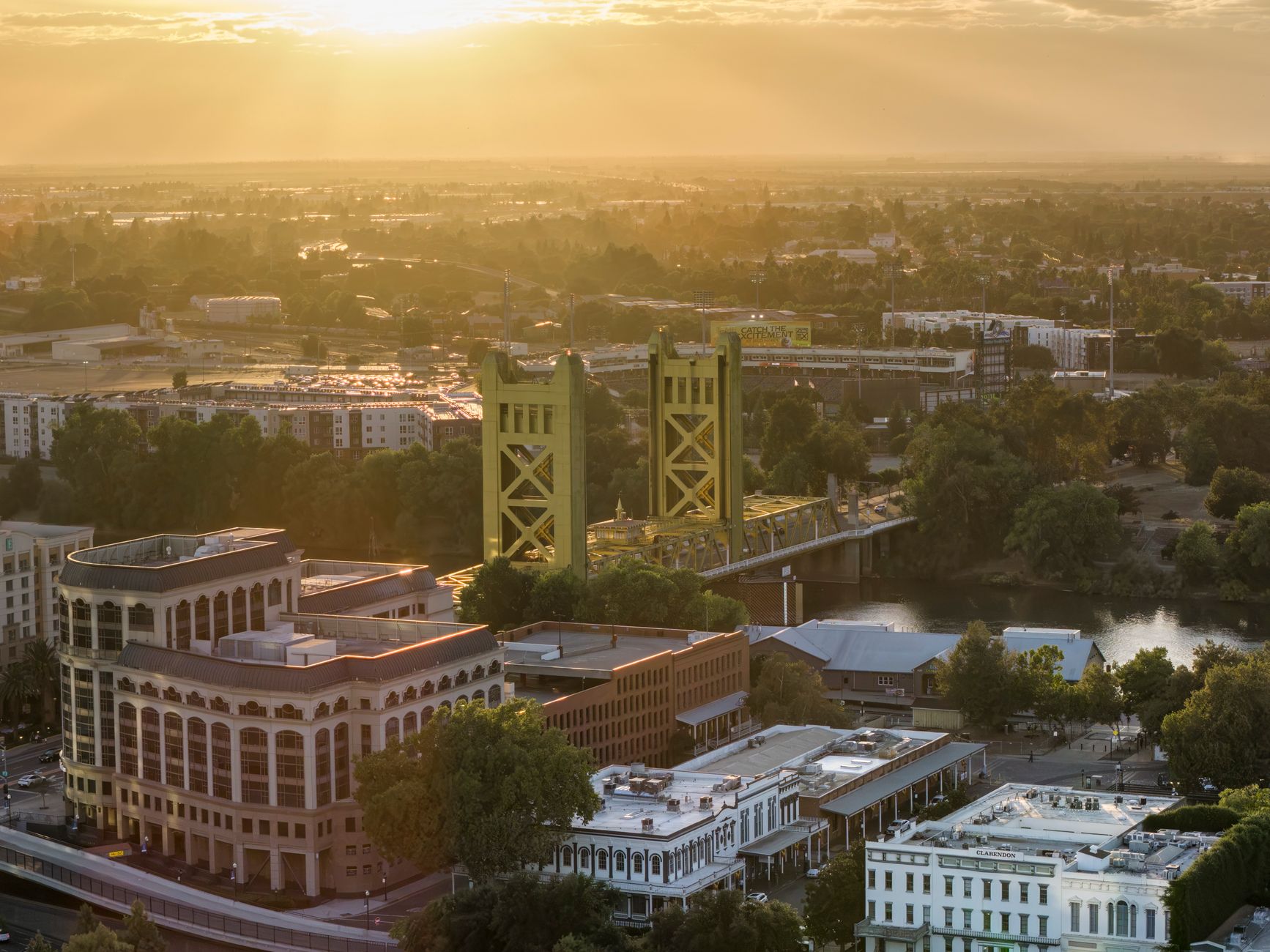 Stunning aerial view of Sacramento's iconic Tower Bridge at sunset, highlighting the city's vibrant skyline.
