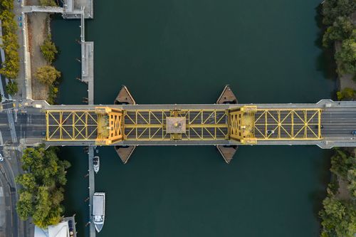 Free Aerial shot of the Tower Bridge in Sacramento, California, showcasing its unique architectural design. Stock Photo