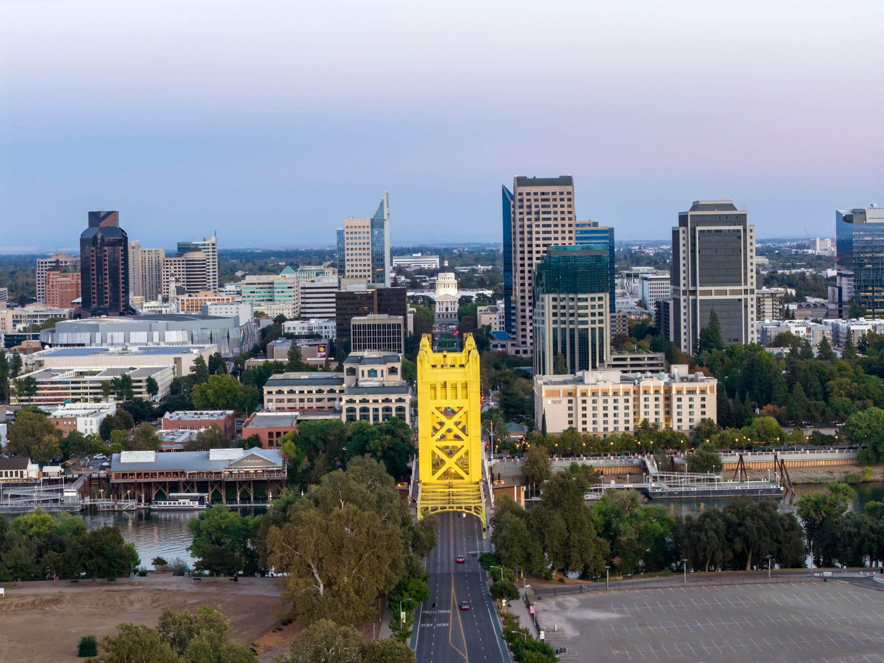 Aerial view of Sacramento showing the iconic Tower Bridge and city skyline at dusk.