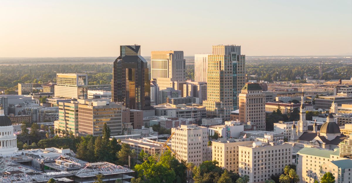 Aerial view of Sacramento skyline with the California State Capitol at sunset, highlighting urban development.
