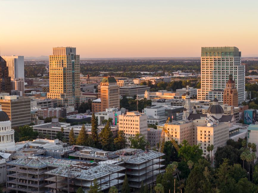 Aerial view of Sacramento skyline during sunset with the Tower Bridge and cityscape in focus.