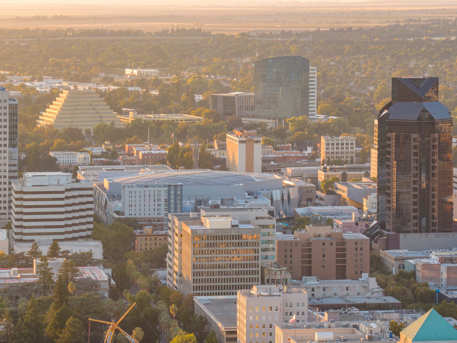 Dramatic aerial view of Sacramento city skyline during sunset, showcasing iconic buildings and rich urban landscape.