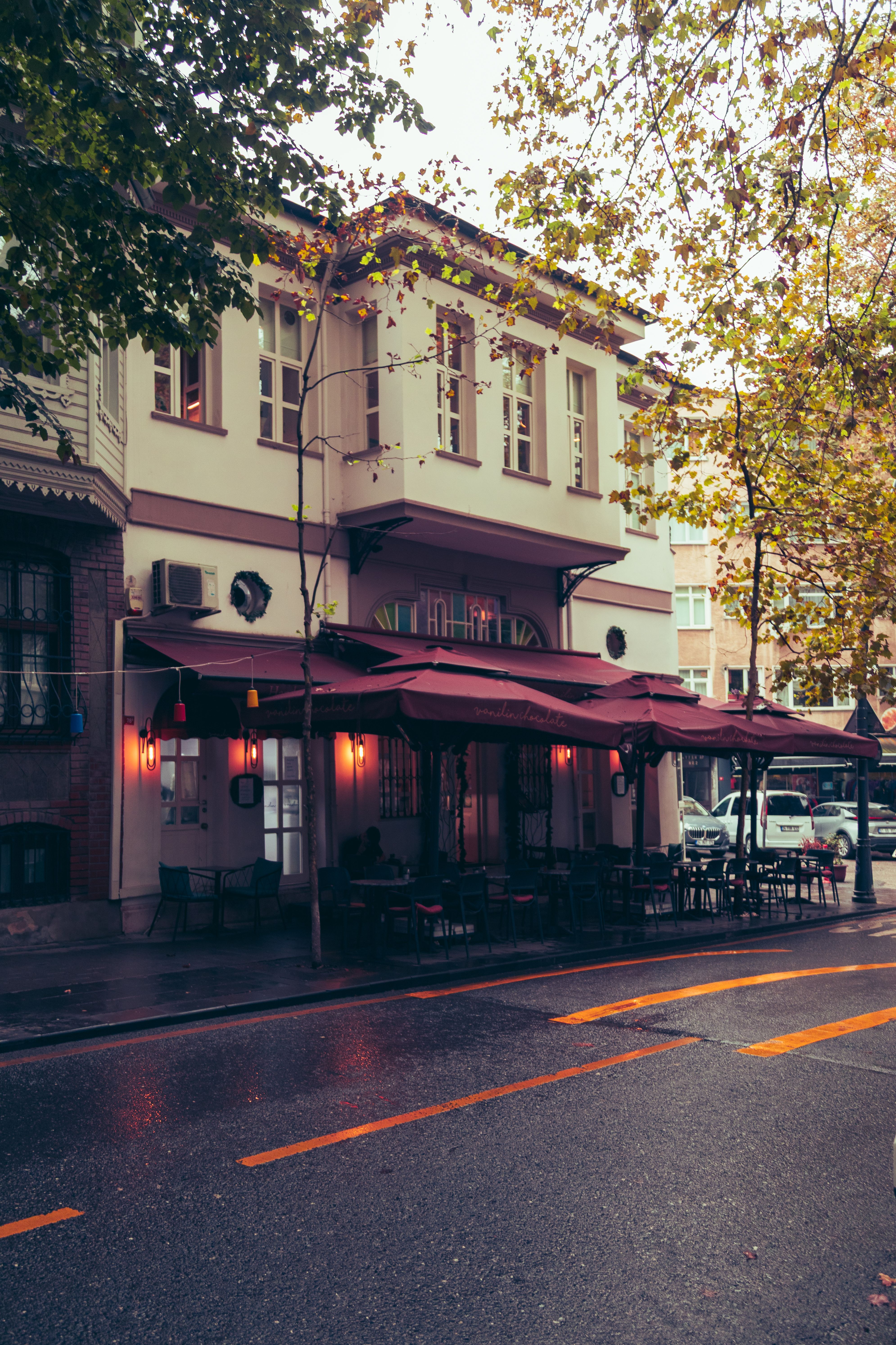 Cozy street cafe in Istanbul with autumn leaves and a serene ambiance.