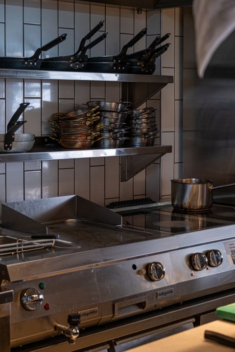 How to Start a Catering Business in Ahmedabad: A 2026 Step-by-Step Guide 3 A large commercial kitchen with stainless steel equipment and pots ready for professional large-scale food preparation.