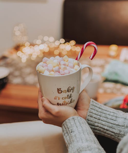 Free Selective Focus Photography of Person Holding Mug With Marshmallows Stock Photo