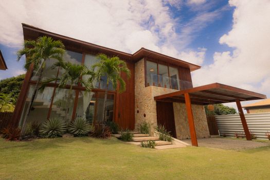 Explore this tropical luxury home featuring modern architecture and lush landscaping.