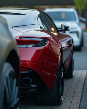 A modern red sports car showcasing sleek, luxury design parked on a city street.