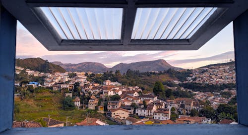 Scenic Photo of City Through Opened Window