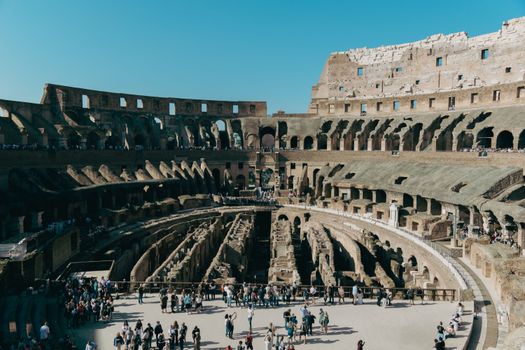 Explore the historical grandeur of the Roman Colosseum with visitors inside, Rome, Italy.
