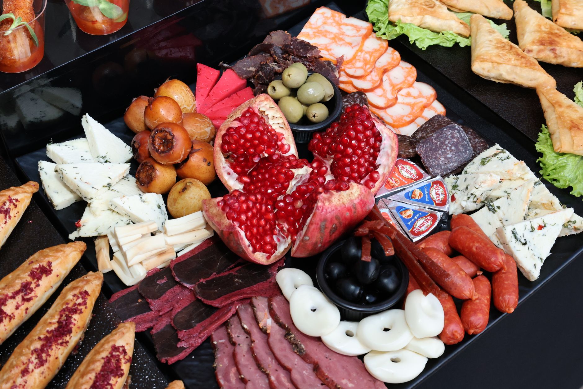 A colorful charcuterie board featuring cheeses, meats, fruits, and vegetables, perfect for a gourmet gathering.
