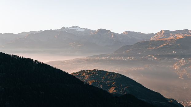 Breathtaking morning view of the Swiss Alps from Anniviers, capturing misty valleys and majestic peaks.
