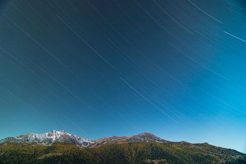 Free Stunning long exposure of star trails above Anniviers mountain range in Valais, Switzerland. Stock Photo