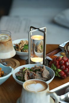 Photo by Andy Lee Sumptuous dining table setup featuring gourmet dishes, sophisticated drinks, and elegant lighting.