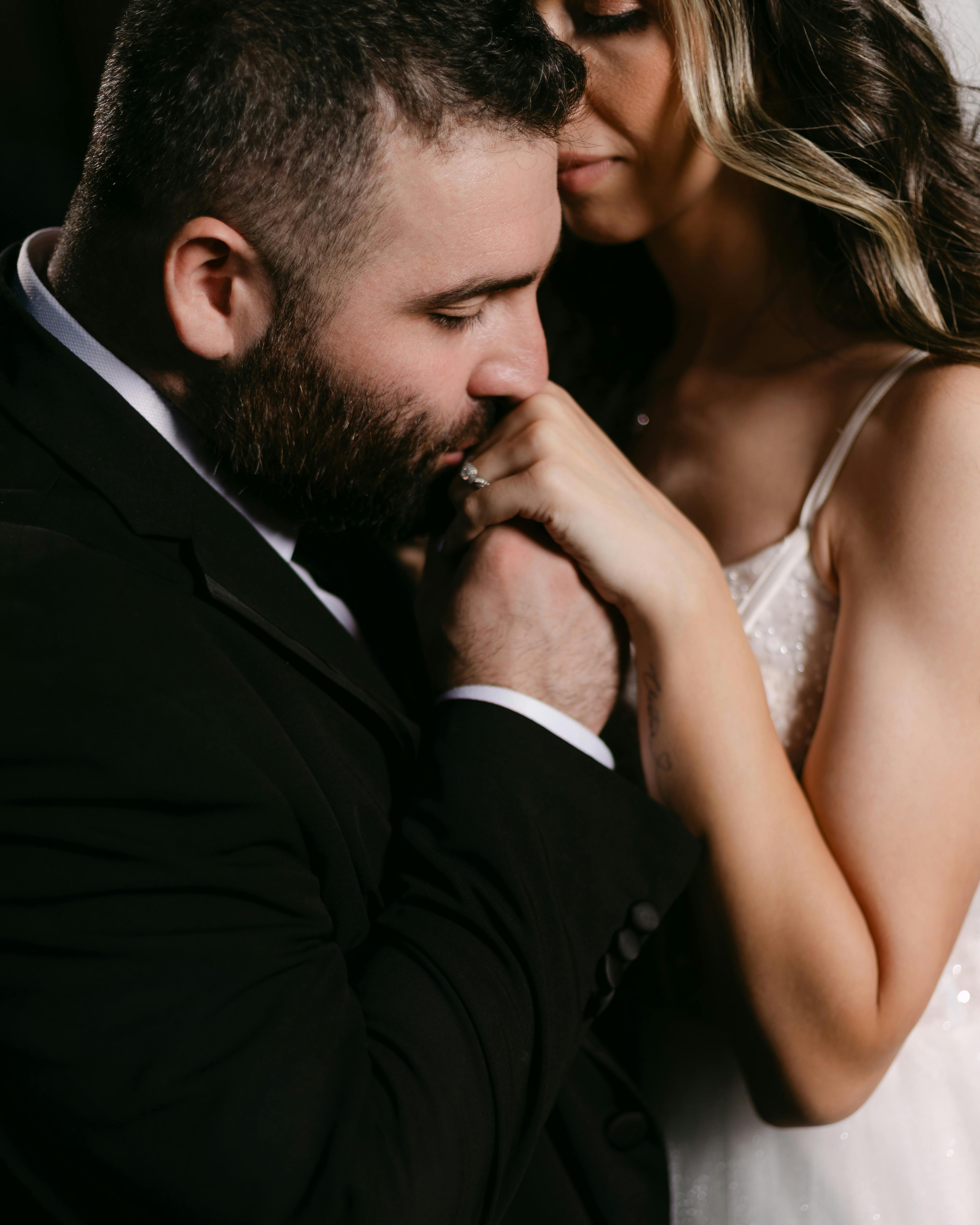 A couple shares a tender moment during their wedding day, capturing emotional connection.