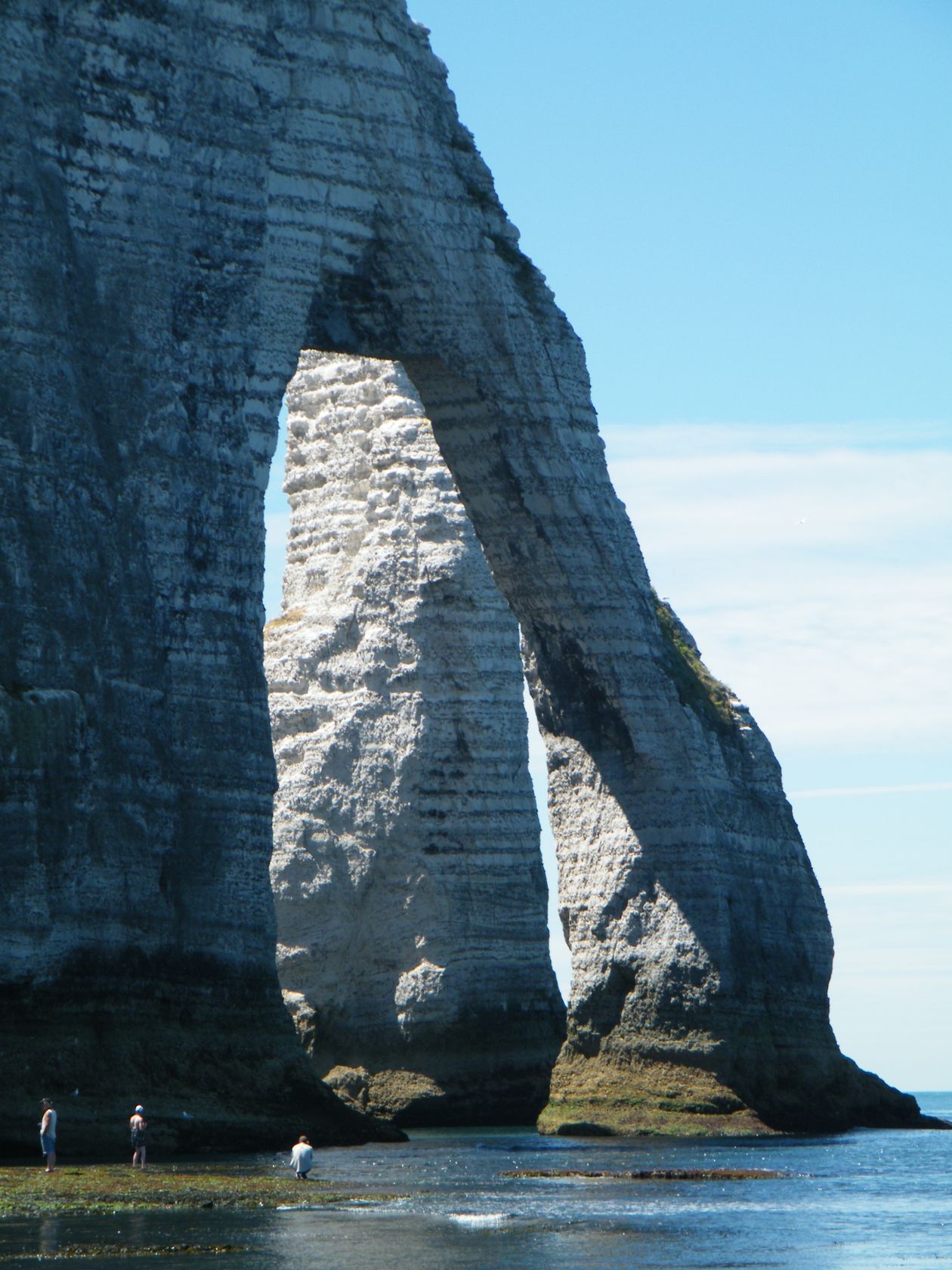 Dramatic white chalk cliffs of Étretat on the Normandy coast with natural rock arch and sea stacks