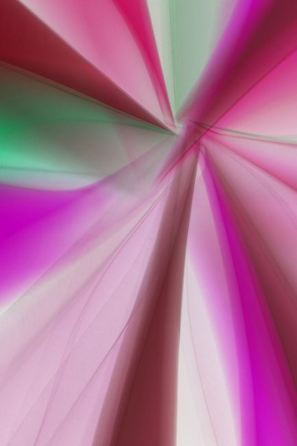 Vibrant abstract image with pink and green light patterns creating an artistic burst effect.