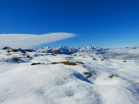 Snowy mountain view with clear blue sky in Beaucens, Occitanie, France.