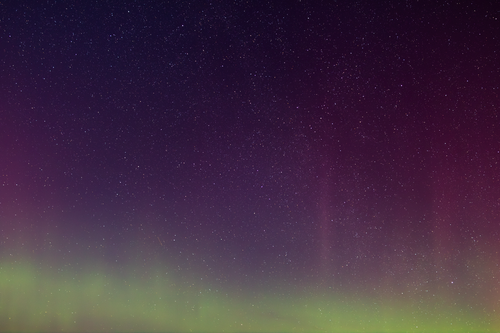 Free A breathtaking view of the aurora borealis and starry night sky in Rågeleje, Denmark. Stock Photo