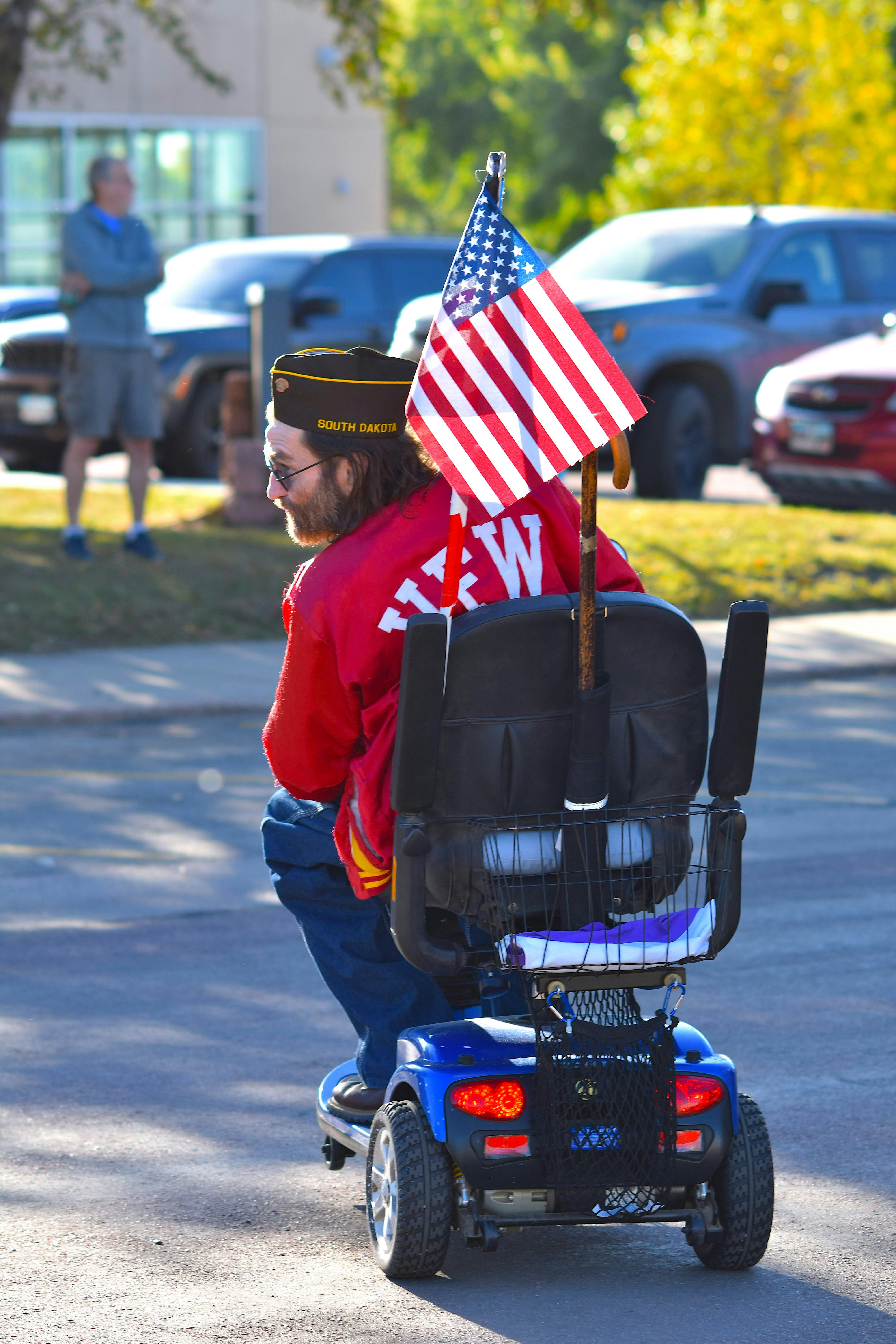 Veteran on mobility scooter with American flag