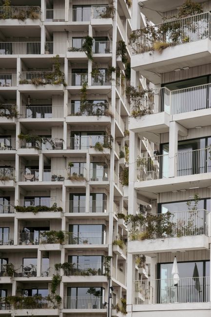 A modern building facade with geometric balconies and greenery in Copenhagen, Denmark.