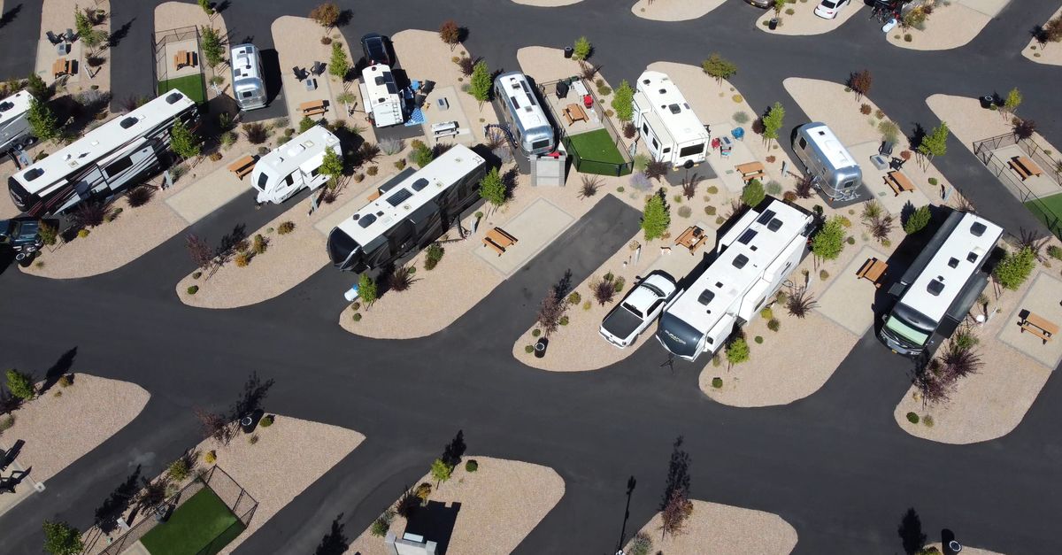 Aerial view of parked RVs in a modern campground on a sunny day.