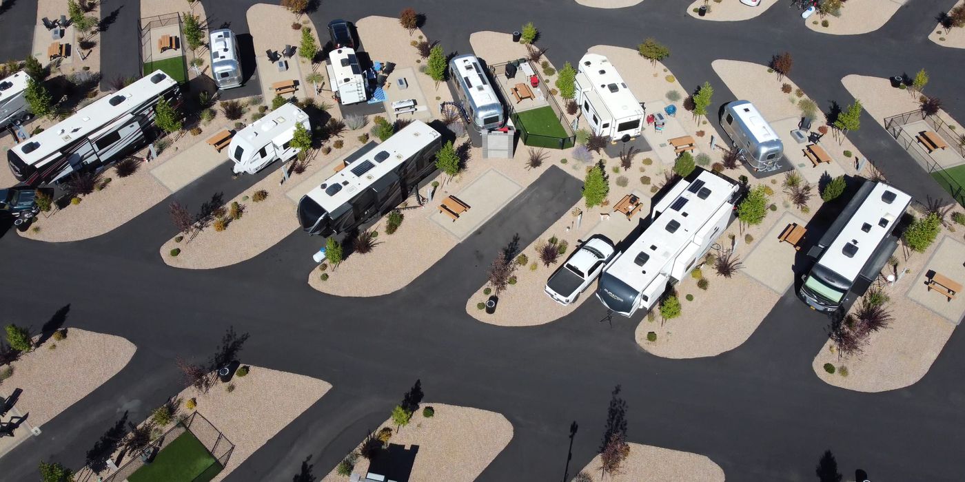 Aerial view of an RV park showing the white roofs of parked motorhomes and trailers
